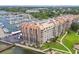 Breathtaking aerial view of the waterfront condo complex with a marina, lush landscaping, and stunning bay views at 634 Edgewater Dr # 744, Dunedin, FL 34698
