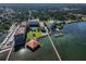 Scenic aerial view showcasing the waterfront condos, boat docks, and lush landscaping at 634 Edgewater Dr # 744, Dunedin, FL 34698