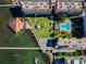Aerial view of the complex featuring the roof tops, swimming pool, docks and green landscape at 634 Edgewater Dr # 744, Dunedin, FL 34698