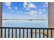 Stunning waterfront view from balcony overlooking clear waters and serene landscape featuring a wooden pier at 634 Edgewater Dr # 744, Dunedin, FL 34698