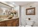 Elegant bathroom featuring a vessel sink, granite countertop, and decorative mirror and wall art at 634 Edgewater Dr # 744, Dunedin, FL 34698