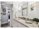 Bright bathroom featuring a granite countertop vanity, modern fixtures, and a view into the adjacent room at 634 Edgewater Dr # 744, Dunedin, FL 34698