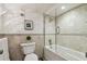 Updated bathroom featuring a jacuzzi tub with glass, modern tiling, and neutral colors at 634 Edgewater Dr # 744, Dunedin, FL 34698