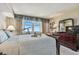 Bedroom featuring a bed and dresser with a telescope pointed towards the water view window at 634 Edgewater Dr # 744, Dunedin, FL 34698