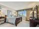 Cozy bedroom with waterfront views, featuring a vintage sewing machine table and comfortable furnishings at 634 Edgewater Dr # 744, Dunedin, FL 34698