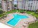 Enjoy a refreshing swim in the community pool surrounded by well-maintained landscaping and lounge chairs at 634 Edgewater Dr # 744, Dunedin, FL 34698