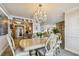 Bright dining room with chandelier and formal table set, adjacent to an open kitchen and living space at 634 Edgewater Dr # 744, Dunedin, FL 34698