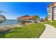 Beautiful waterfront building featuring a waterside structure and manicured green spaces at 634 Edgewater Dr # 744, Dunedin, FL 34698