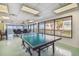 Recreational game room featuring a ping pong table and natural light, providing entertainment and social opportunities at 634 Edgewater Dr # 744, Dunedin, FL 34698