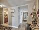 Hallway featuring unique patterned wallpaper, decorative lighting, and tiled flooring at 634 Edgewater Dr # 744, Dunedin, FL 34698