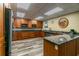 Well-equipped kitchen with stainless steel appliances, wooden cabinets, and sleek countertops at 634 Edgewater Dr # 744, Dunedin, FL 34698