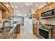 Well-equipped kitchen featuring stainless steel appliances, granite countertops, and a seamless transition to the dining area at 634 Edgewater Dr # 744, Dunedin, FL 34698