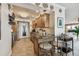 Well-lit kitchen with granite countertops, stainless steel appliances, and bar seating with modern pendant lighting at 634 Edgewater Dr # 744, Dunedin, FL 34698