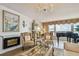 Inviting living room with fireplace, plush armchairs, elegant decor, and grand piano with beautiful waterfront views at 634 Edgewater Dr # 744, Dunedin, FL 34698