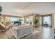 Elegant living room with a grand piano, chandelier, and panoramic water views at 634 Edgewater Dr # 744, Dunedin, FL 34698