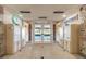Well-lit building lobby features mailboxes, stone accents, tile flooring, and glass doors leading to the exterior at 634 Edgewater Dr # 744, Dunedin, FL 34698