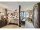Comfortable main bedroom with four-poster bed, water view, and dark wood furniture at 634 Edgewater Dr # 744, Dunedin, FL 34698