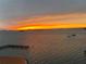 Beautiful sunset view over the water, showcasing vibrant orange and yellow hues at 634 Edgewater Dr # 744, Dunedin, FL 34698
