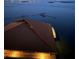 Beautiful waterfront view at twilight featuring a private dock and seawall at 634 Edgewater Dr # 744, Dunedin, FL 34698