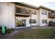 Rear exterior showcasing patios and balconies of the condominium building at 7750 92Nd St # 103, Seminole, FL 33777