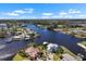 Stunning aerial view of the waterfront property with private docks, a canal and surrounding homes at 829 Blue Heron Blvd, Ruskin, FL 33570