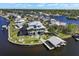 Wide aerial shot of the home, waterfront, boat dock, and surrounding neighborhood at 829 Blue Heron Blvd, Ruskin, FL 33570