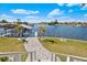 Waterfront backyard with boat dock and lush tropical landscaping at 829 Blue Heron Blvd, Ruskin, FL 33570