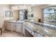Bathroom featuring dual sinks and a jacuzzi tub at 829 Blue Heron Blvd, Ruskin, FL 33570
