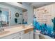 Bathroom with double sink vanity and a shower/tub combination with a decorative shower curtain at 829 Blue Heron Blvd, Ruskin, FL 33570