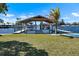 Backyard waterfront boat dock with electric boat lifts and green lawn at 829 Blue Heron Blvd, Ruskin, FL 33570