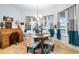 Bright dining room with a wooden table, floral chairs, and large windows with curtains at 829 Blue Heron Blvd, Ruskin, FL 33570