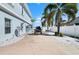 Driveway shows extra parking and space for a boat and is lined with white rocks and mature palms at 829 Blue Heron Blvd, Ruskin, FL 33570