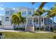 Beautiful home showcasing manicured lawn, a two-car garage, columns and a inviting front porch at 829 Blue Heron Blvd, Ruskin, FL 33570