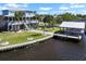 Waterfront home features a private boat dock, screened-in lanai, lush landscaping, and two stories at 829 Blue Heron Blvd, Ruskin, FL 33570