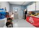 Garage featuring ample counter space, a refrigerator, and an exterior door with a window at 829 Blue Heron Blvd, Ruskin, FL 33570
