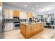 Open kitchen with stainless steel appliances and a large center island with a sink at 829 Blue Heron Blvd, Ruskin, FL 33570