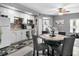 Kitchen featuring white cabinets, stainless steel appliances, and a dining area at 829 Blue Heron Blvd, Ruskin, FL 33570