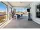 Enclosed Lanai with canal views, ceiling fan and outdoor TV at 829 Blue Heron Blvd, Ruskin, FL 33570