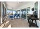 Screened lanai with outdoor seating, a ceiling fan, and water views at 829 Blue Heron Blvd, Ruskin, FL 33570