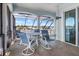 Screened-in lanai with outdoor seating and water views at 829 Blue Heron Blvd, Ruskin, FL 33570