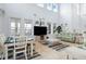 Bright living room with large windows, high ceilings, and tile floors at 829 Blue Heron Blvd, Ruskin, FL 33570