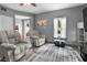Living room with gray recliners, a glass-top coffee table, and a view of the outdoors at 829 Blue Heron Blvd, Ruskin, FL 33570