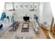 Open-concept living room boasts tile floors, soaring ceilings, and backyard views from the wall of windows at 829 Blue Heron Blvd, Ruskin, FL 33570