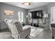 Living room featuring comfortable recliners, a television, and a glass-top coffee table at 829 Blue Heron Blvd, Ruskin, FL 33570