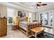 Spacious main bedroom featuring an attached balcony, tray ceilings, and rustic wood furniture at 829 Blue Heron Blvd, Ruskin, FL 33570