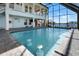 Enclosed in ground pool with in-water seating and scenic canal views at 829 Blue Heron Blvd, Ruskin, FL 33570
