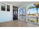 Cozy screened-in porch with tile flooring, white columns, and views of the tranquil waterfront at 829 Blue Heron Blvd, Ruskin, FL 33570