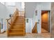 Beautiful wooden staircase with tiled floors and elevator access for easy accessibility to all levels of the home at 829 Blue Heron Blvd, Ruskin, FL 33570