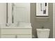 Bathroom with toilet, vanity and mirror features neutral paint and natural light at 9640 Runaway Breeze Dr, Land O Lakes, FL 34637