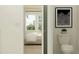 Modern bathroom with a toilet and a partial view of a bedroom in the background at 9640 Runaway Breeze Dr, Land O Lakes, FL 34637